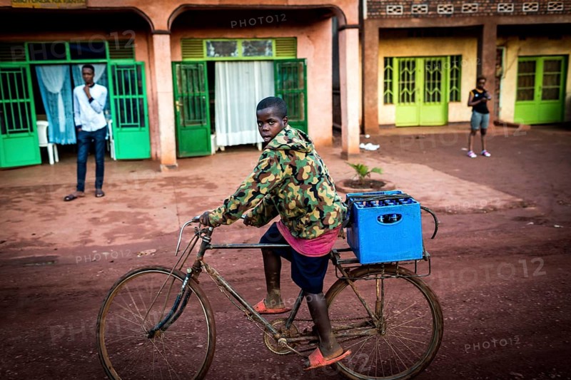 RWA RWANDA Rwanda Rukara A cyclist wearing a camouflage jacket transports drinks