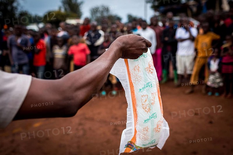 TZA TANZANIA Benaco A representative for Pampers nappies offers his product on a marketplace