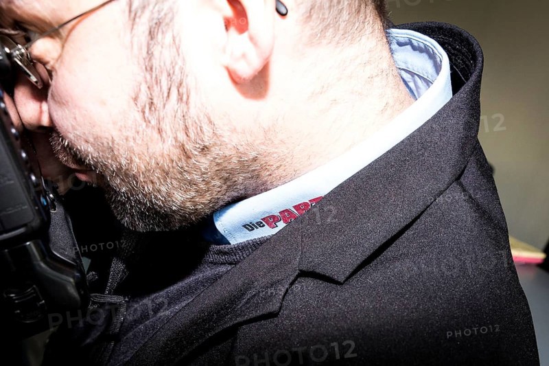 DEU Germany Germany Berlin Trial against Die Partei begins at the Berlin Administrative Court. The German Bundestag is demanding the return of subsidies that the satirists' party had received from the federal government through the 'Buy Money' campaign. Photographer with shirt bearing the 'Die Partei' logo