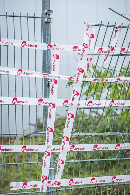 DEU Germany Germany Berlin The fence around an Air Berlin hangar on Saatwinkler Damm has been repaired with the airline's own adhesive tape. The airline will cease flight operations on 28 October