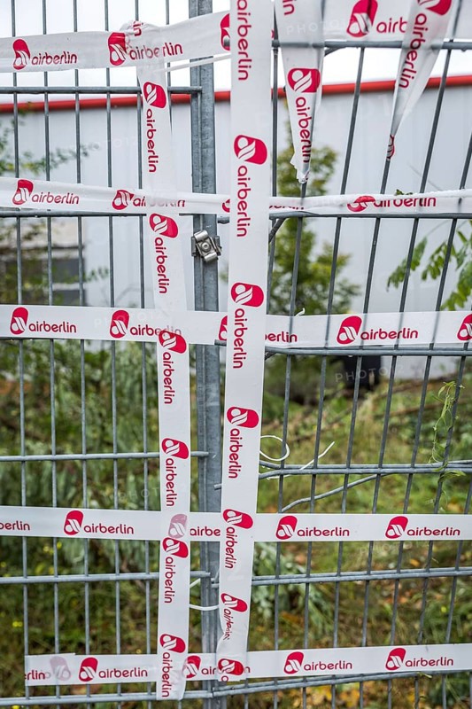 DEU Germany Germany Berlin The fence around an Air Berlin hangar on Saatwinkler Damm has been repaired with the airline's own adhesive tape. The airline will cease flight operations on 28 October