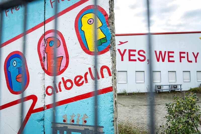 DEU Germany Germany Berlin A closed Air Berlin hangar with graffiti by Thierry Noir on pieces of the Berlin Wall on Saatwinkler Damm. The airline will cease operations on 28 October