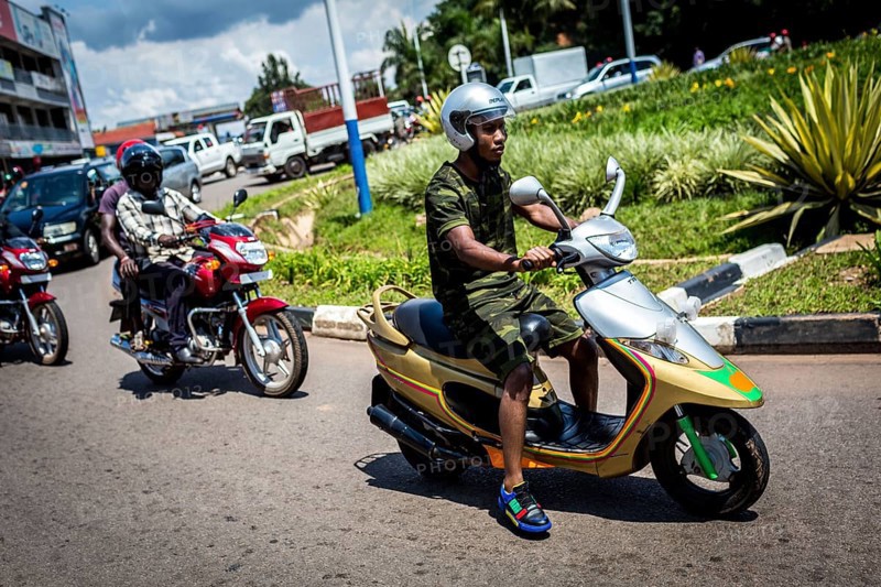 RWA RWANDA RUANDA Kigali A youth in camouflage fashion on a scooter