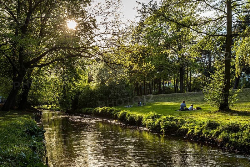 DEU Germany Germany Berlin People enjoying the sun on the banks of the Panke in Bürgerpark Pankow