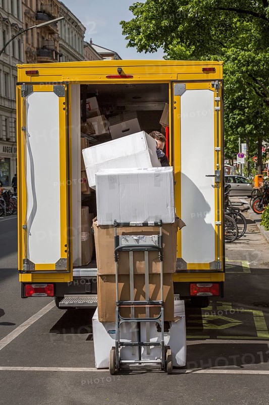 DEU Germany Germany Berlin A courier delivers parcels on Bergmannstrasse