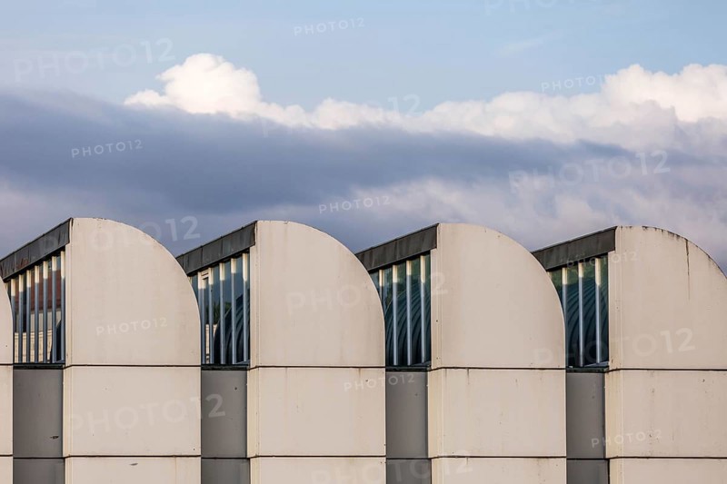 DEU Germany Germany Berlin The towers of the Bauhaus Museum are lined up against a cloudy sky. The archive is currently being renovated and remodelled