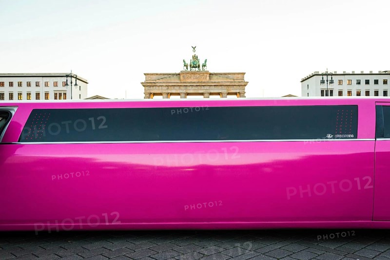 DEU Germany Germany Berlin Pink stretch limousine in front of the Brandenburg Tor