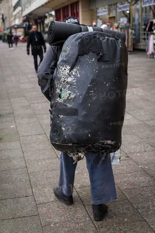 DEU Germany Germany Berlin A homeless man carries a huge bag with his belongings through the city