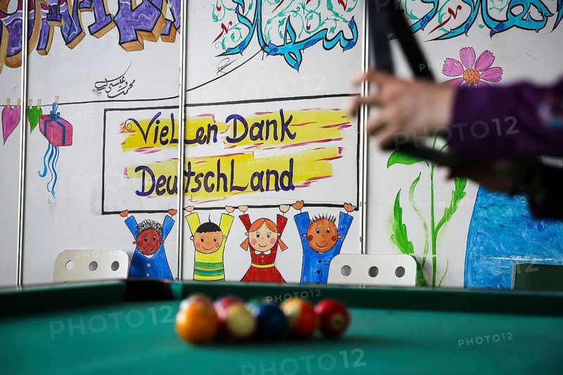 DEU Germany Germany Berlin As part of the German Foundation Week, the Cologne-based organisation Rheinflanke demonstrates sports facilities for refugees in the hangar at Tempelhof Airport. Refugees play billiards in Hangar 1
