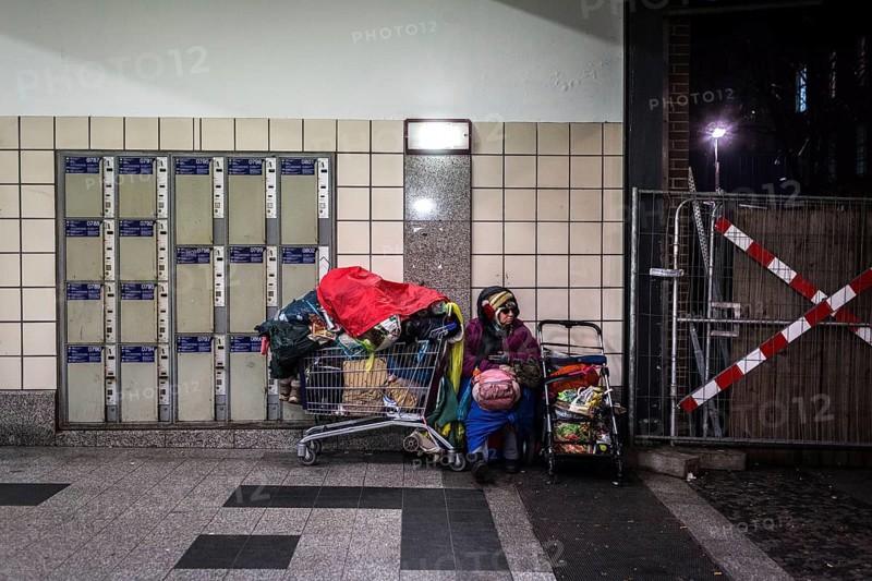 DEU Germany Germany Berlin Scenes of homeless people around Bahnhof Zoo. Woman with her belongings sitting next to lockers