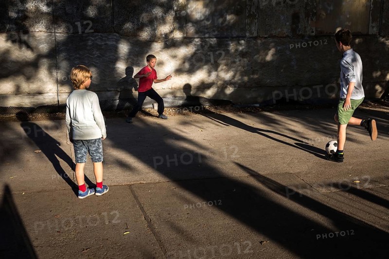 DEU Germany Germany Berlin Children play football while their parents watch a World Cup match in the Prater beer garden