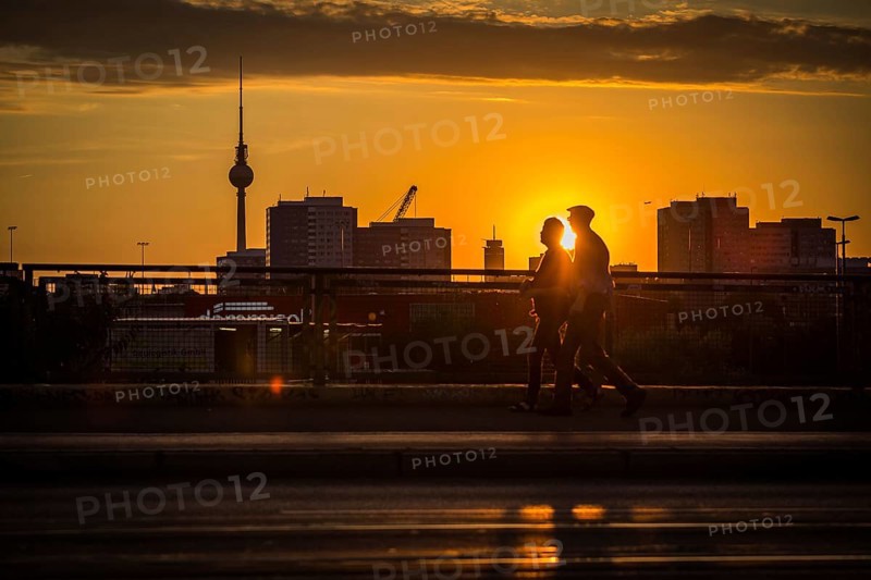 DEU Germany Germany Berlin Cyclists and pedestrians at sunset on the Warsaw Bridge