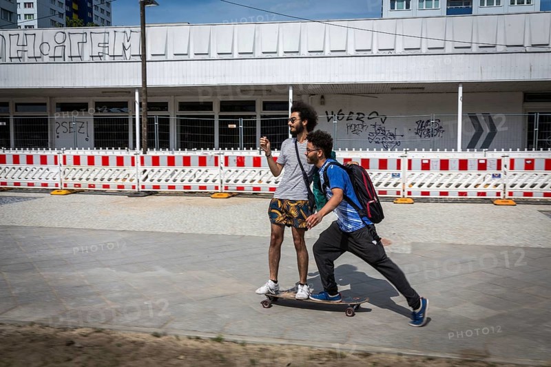 DEU Germany Germany Berlin Two friends move through Berlin on a skateboard