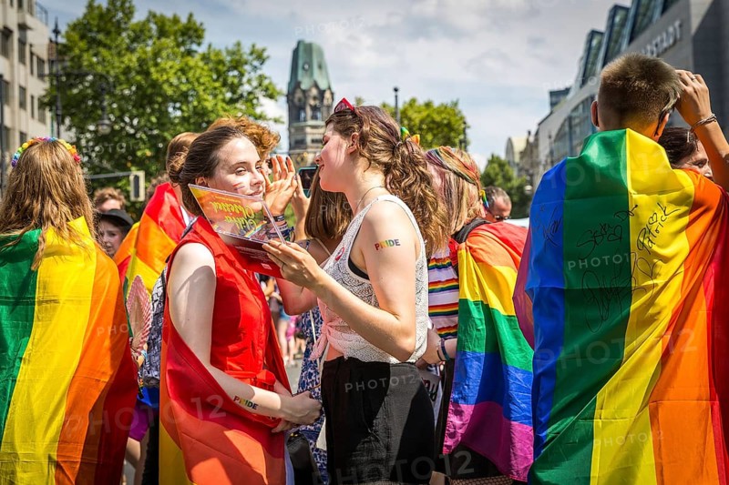 DEU Germany Germany Berlin Scenes from Christopher Street Day CSD on a hot Saturday . Young people touching up their make-up