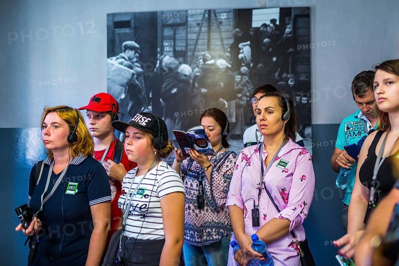 POL Poland Poland Auschwitz Visitors listen to their audio guide at the memorial site of the former Auschwitz concentration camp
