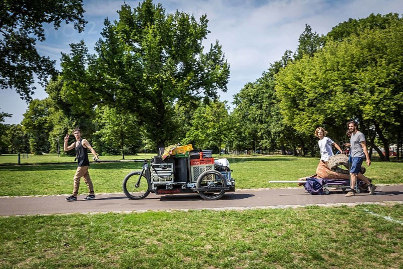 DEU Germany Germany Berlin Young men transporting technology for an event through Volkspark Friedrichshain
