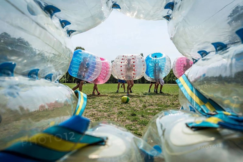 DEU Germany Germany Berlin A group of Dutch tourists playing bubblesoccer in a meadow in Volkspark Friedrichshain