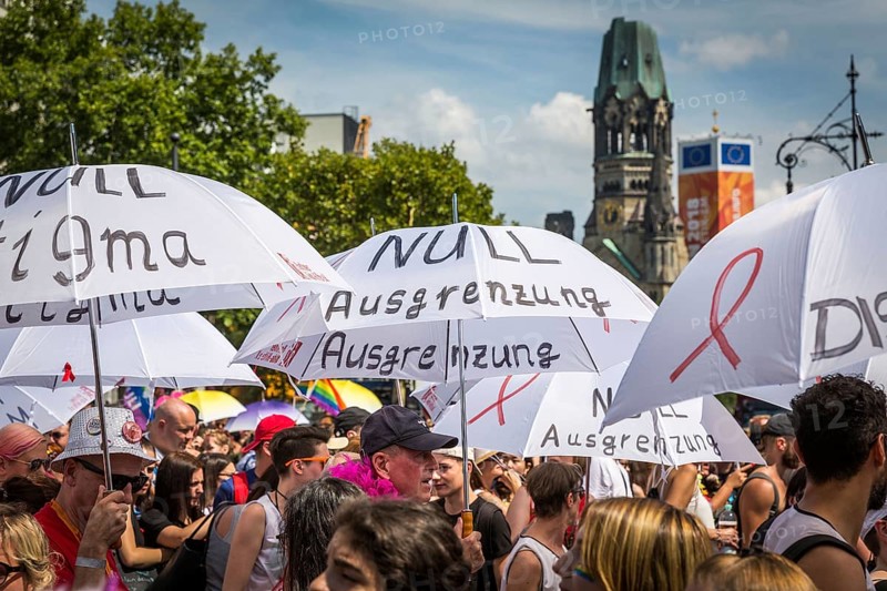 DEU Germany Germany Berlin Scenes from Christopher Street Day CSD on a hot Saturday . Action with umbrellas of the Aids Hilfe