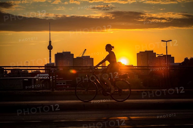 DEU Germany Germany Berlin Cyclists and pedestrians at sunset on the Warsaw Bridge
