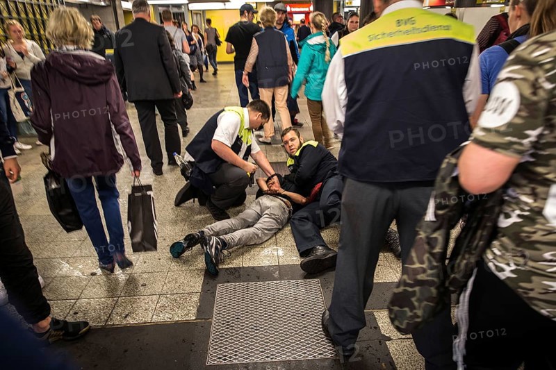 DEU Germany Germany Berlin BVG security staff hold a man on the ground in the subway at Zoo station
