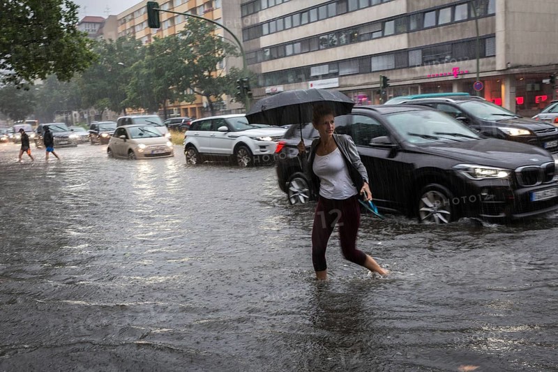 DEU Germany Germany Berlin Scene of the storm in Berlin. People cross the flooded Bundesallee