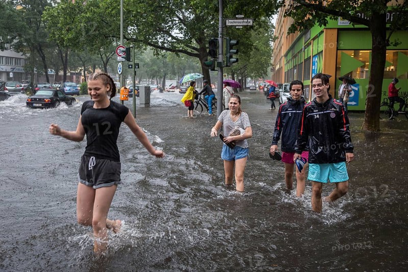 DEU Germany Germany Berlin Scene of the storm in Berlin. Young people cross the flooded Trauenaustrasse