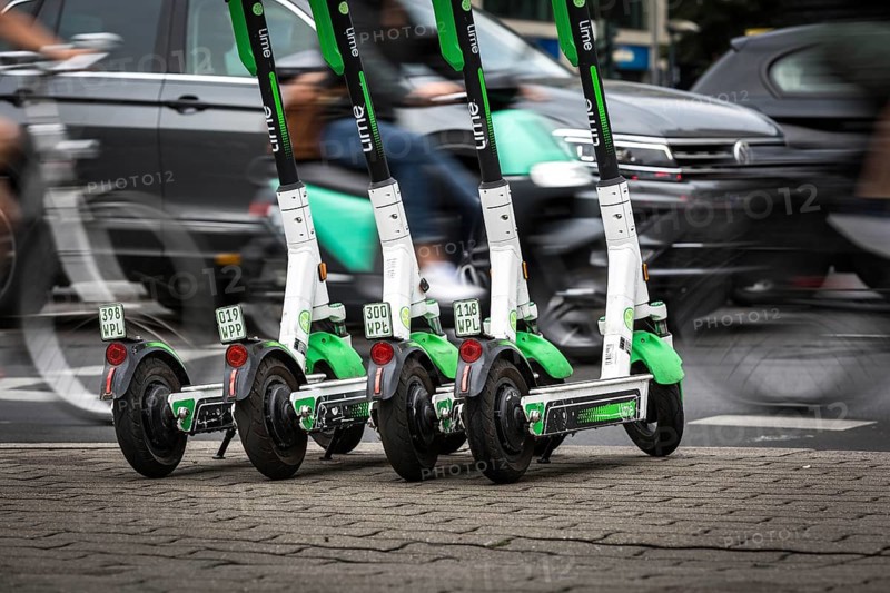 DEU Germany Germany Berlin Traffic passes parked e-scooters on Karl-Liebknecht-Str