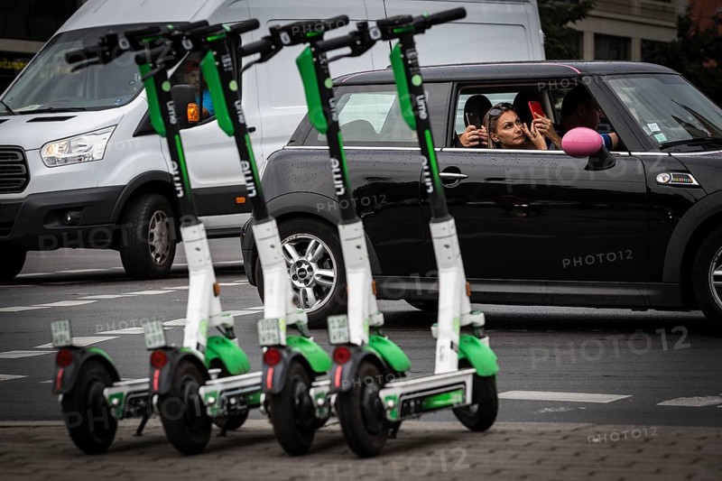 DEU Germany Germany Berlin Traffic passes parked e-scooters on Karl-Liebknecht-Str