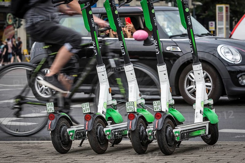 DEU Germany Germany Berlin Traffic passes parked e-scooters on Karl-Liebknecht-Str