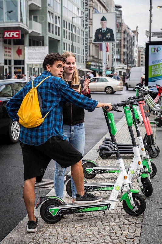 DEU Germany Germany Berlin Tourists with e-scooters at Checkpoint Charlie
