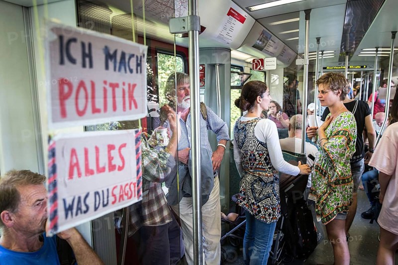DEU Germany Germany Berlin Students discuss the G20 summit on the Berlin S-Bahn. A loose group of activists meet irregularly to discuss political issues with passengers over tea and food on the Ringbahn railway line