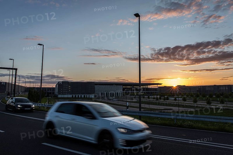 DEU Germany Germany Berlin Cars pass the future BER Berlin-Brandenburg airport at sunset
