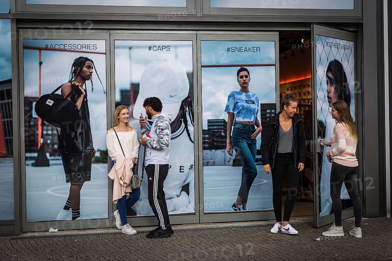 DEU Germany Germany Berlin Teeenager in front of a shop at Alexanderplatz