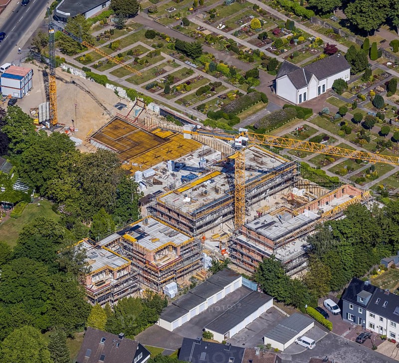 Aerial view, construction site new residential buildings, former Opel car dealership Brinkmann site, Bredenscheider Straße, Evang. Cemetery at the water tower, Hattingen, Ruhr area, North Rhine-Westphalia, Germany, construction area, building site, building plots, building crane, construction project, construction site, burial site, DE, Ennepe-Ruhr district, Europe, cemetery, memorial, place of worship, graves, burial ground, capacity requirement, aerial photograph, aerial photography, aerial photography, new building, resting place, overview, bird's-eye view, living and life, birds-eyes view, overview