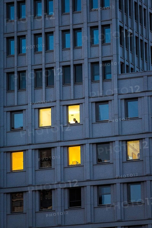 DEU Germany Germany Berlin A man sits in an illuminated office in the Beisheim Centre