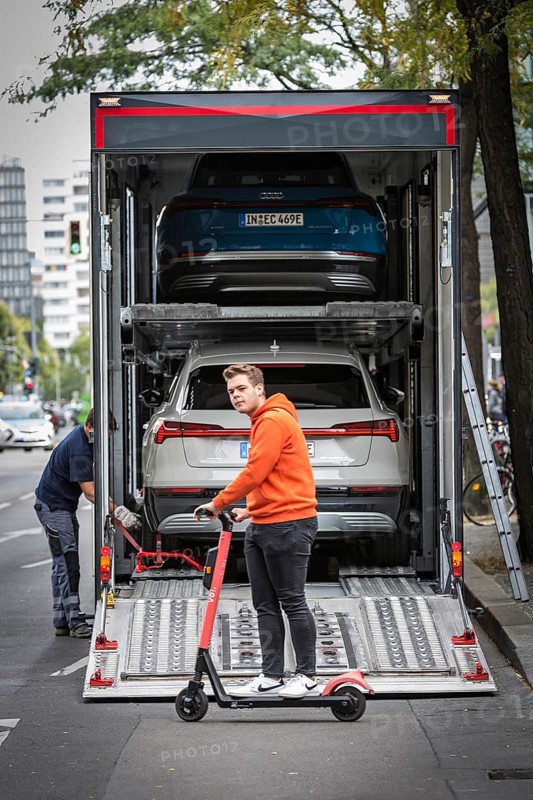 DEU Germany Germany Berlin SUVs with electric motors are loaded onto a transporter in Kantstrasse. The vehicles were prepared for transport on Kantstrasse after a presentation by Audi