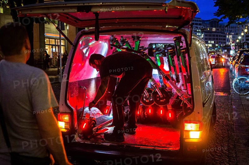DEU Germany Germany Berlin So-called juicers collect discharged electric scooters at Potsdamer Platz