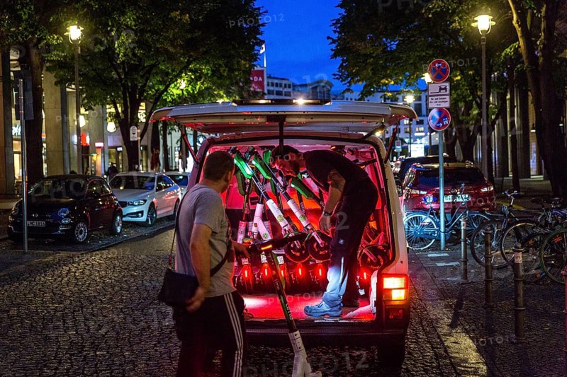 DEU Germany Germany Berlin So-called juicers collect discharged electric scooters at Potsdamer Platz