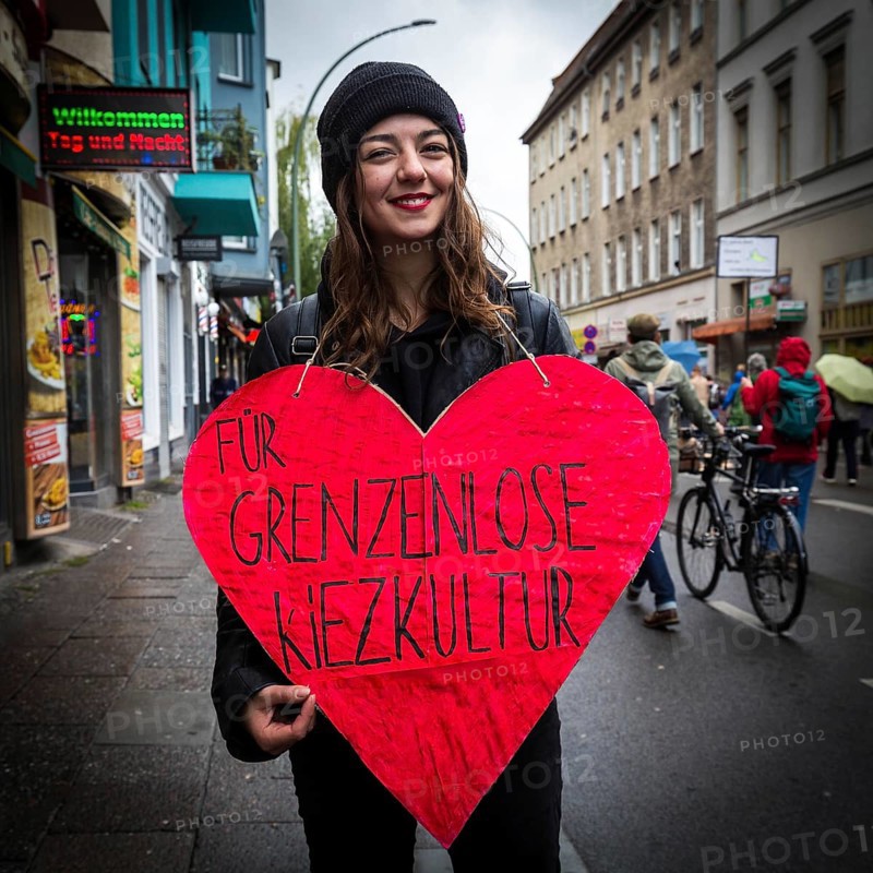 DEU Germany Germany Berlin Demonstration against rent increases and gentrification.woman demonstrates with heart for borderless neighbourhood culture