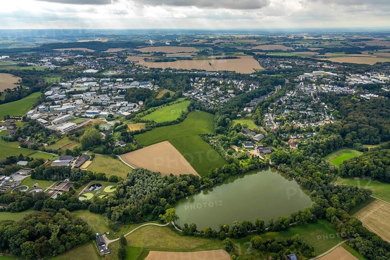 Aerial view, industrial estate Hetterscheidt-Nord, Dieselstraße, Abtskücher Teich, chapel St. Jakobus Abtsküche, Museum Abtsküche, view of Hetterscheidt, Heiligenhaus, Ruhr area, North Rhine-Westphalia, Germany, place of worship, DE, Europe, commercial enterprises, commercial area, commercial park, commercial location, commercial use, religious community, place of worship, green trees, local history collection, Heiligenhaus historical society, industrial area, industrial site, chapel, church, church community, denomination, aerial view, aerial photography, aerial photography, museum, religion, overview, bird's-eye view, forest area, birds-eyes view, overview