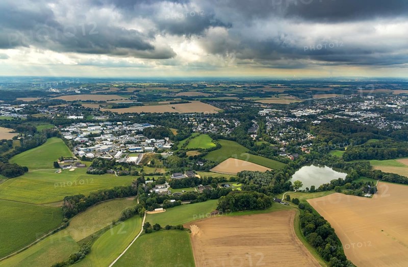 Aerial view, industrial estate Hetterscheidt-Nord, Dieselstraße, Abtskücher Teich, chapel St. Jakobus Abtsküche, Museum Abtsküche, view of Hetterscheidt, Heiligenhaus, Ruhr area, North Rhine-Westphalia, Germany, place of worship, DE, Europe, commercial enterprises, commercial area, commercial park, commercial location, commercial use, religious community, place of worship, green trees, local history collection, Heiligenhaus historical society, industrial area, industrial site, chapel, church, church community, denomination, aerial view, aerial photography, aerial photography, museum, religion, overview, bird's-eye view, forest area, birds-eyes view, overview