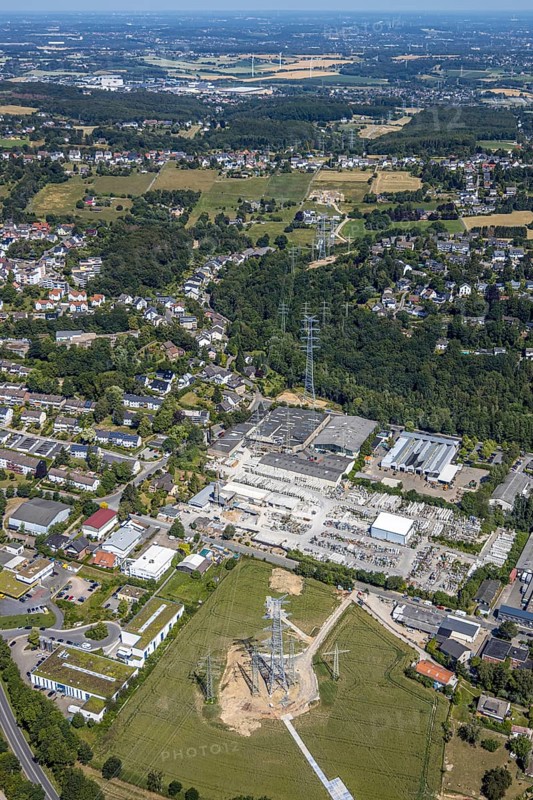 Aerial view, industrial estate Loerfeld, Basamentwerke Böcke GmbH, construction site power line, end, Herdecke, Ruhr area, North Rhine-Westphalia, Germany, construction work, construction area, construction site, construction measure, construction project, construction site, DE, Europe, commercial area, commercial area, commercial use, green trees, industrial site, Loerfeldstraße, aerial view, aerial photography, aerial photography, power pylons, power line, overview, bird's eye view, birds-eyes view, overview