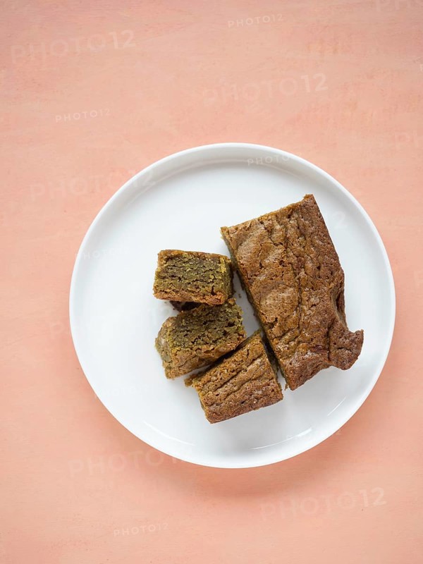 Group of matcha blondies on a white plate, prepared for a sweet treat