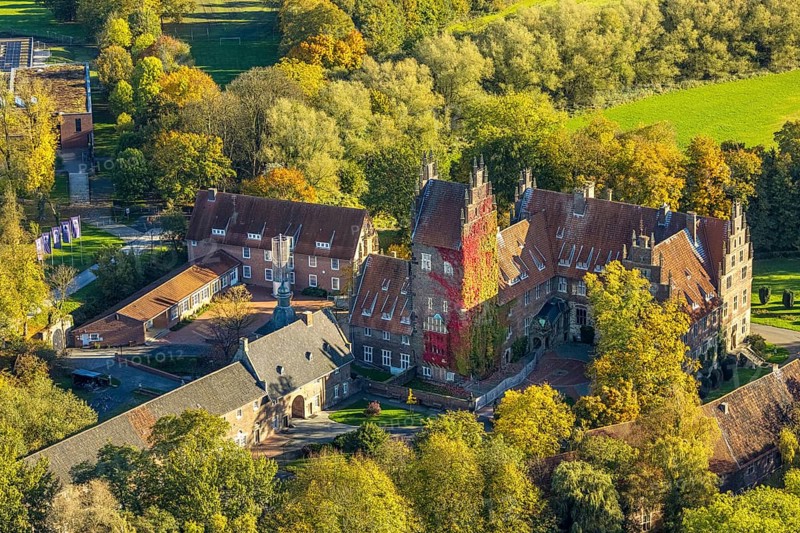 Aerial view, Heessen Castle private school and boarding school, colorful house façade with plant growth, stork nest on the roof fireplace, autumn trees, Heeßen district, Hamm, Ruhr area, North Rhine-Westphalia, Germany, castle, trees in autumn colors, DE, roof, Europe, autumn, autumn colors, autumn atmosphere, aerial photography, aerial photography, nest, castle, stork tower, overview, bird's-eye view, bird's-eye view, birch DS-eyes view, overview