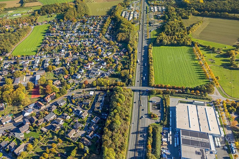 Aerial view, meadow area surrounded by autumn trees on the A2 motorway, Wambelner Straße bridge, Rhynern rest area behind, truck parking lot, district of Herringen, Hamm, Ruhr area, North Rhine-Westphalia, Germany, burial place, DE, Europe, cemetery, memorial, Gottesacker, graves, burial ground, aerial photo, aerial photography, resting place, road traffic, overview, bird's eye view, birds-eyes view, overview