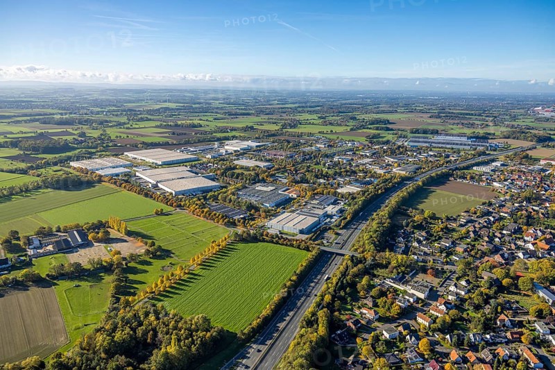 Aerial view, Oberster Kamp industrial estate on the A2 motorway, meadow area surrounded by autumn trees on the A2 motorway, meadows and fields with a distant view, bridge Wambelner Straße over the motorway, in the back the EDEKA central warehouse Hamm, Rhynern district, Hamm, Ruhr area, North Rhine-Westphalia, Germany, DE, Europe, commercial space, industrial park, commercial site, commercial use, industrial area, industrial site, aerial view, aerial photography, aerial photography, overview, bird's eye view, birds-eyes view, overview