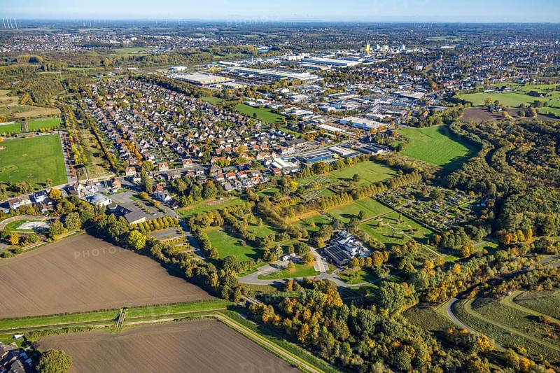 Aerial view, Isenbecker Hof residential area, Neue Kolonie mining settlement, Herringen park cemetery, Hamm Krematorium GmbH, Lippepark barefoot path, in the back the Hafenstraße industrial park, autumn trees, Herringen district, Hamm, Ruhr area, North Rhine-Westphalia, Germany, workers' housing estate, burial ground, trees in autumn colors, DE, Europe, cemetery, memorial, commercial establishment, area, commercial area, commercial property, commercial use, Gottesacker, property tax, graves, burial ground, autumn colors, autumn mood, real estate, industrial area, industrial site, aerial photography, aerial photography, resting place, overview, bird's eye view, residential complex, housing and living, residential area, residential district, residential district, birds-eyes view, overview