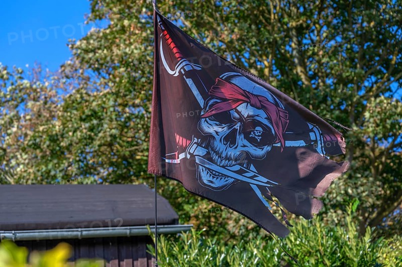 Pirate flag in a garden, Ahrenshoop, Darß, Mecklenburg-Western Pomerania, Germany