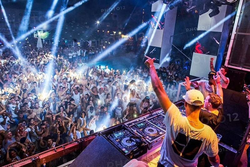 EDITORIAL and NEWS ONLY, rare moment of joint DJ back to back performance of edm dance music DJ Afrojack (on top, the person standing up on DJ pult) performing with DJ Hardwell on DJ pult at Starbeach events festival Hersonissos, Crete, Greece, on 17. July 2017