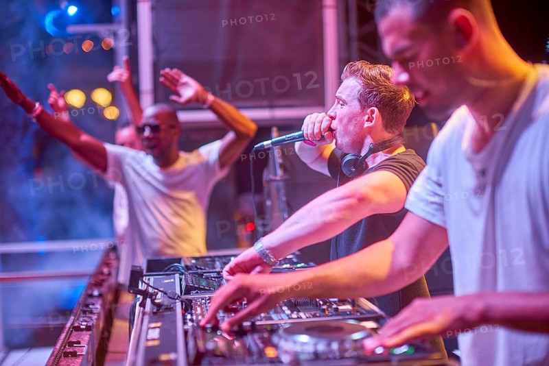 EDITORIAL and NEWS ONLY, rare moment of joint DJ back to back performance of edm dance music DJ Hardwell (in the middle) performing next to DJ Afrojack (at the right) on DJ pult at Starbeach events festival Hersonissos, Crete, Greece, on 17. July 2017
